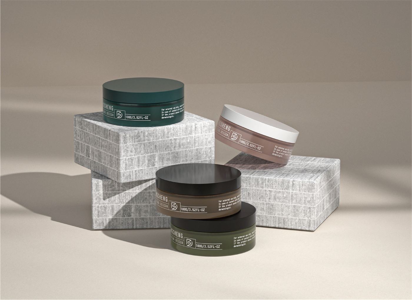 Four flat cream jars in green, brown, and taupe on stone blocks